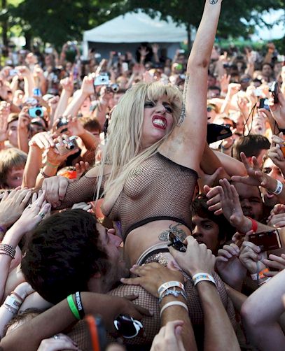 Here's Lady GaGa doing a little bit of stage diving while wearing a very