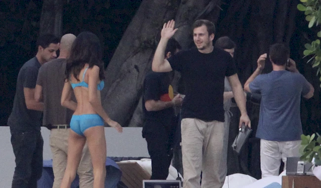 Model in underwear with her backside turned while on the set of a photo shoot