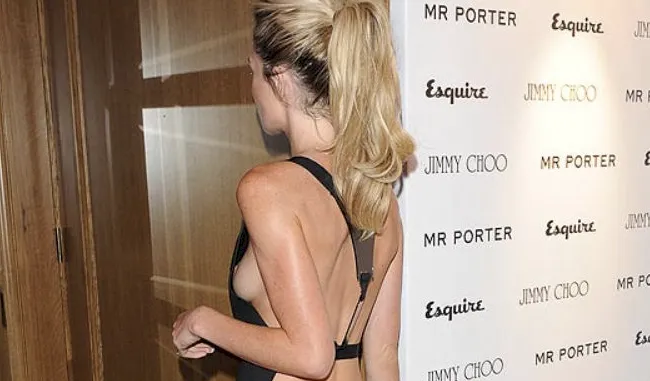 Abbey Clancy braless nipple slip from the side as she steps into a building