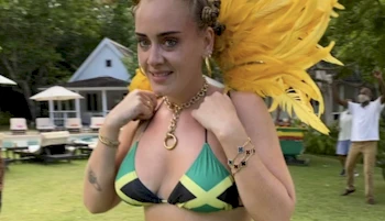 Adele in a bikini top shaped like the Jamaican flag