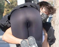 Addison Rae's butt in leggings while a man carries her over his shoulder