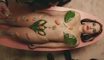 Nude woman seen from above with Sushi on her body