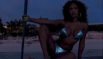 Ebony babe in a shiny bikini spread her legs on a paddleboard in the dark