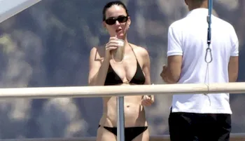 Popstar Katy Perry in a black bikini and enjoying a drink on a yacht