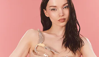 Pretty brunette posing in front of a pink background