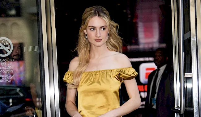 Pretty blonde in a yellow dress walking out on the street in NYC