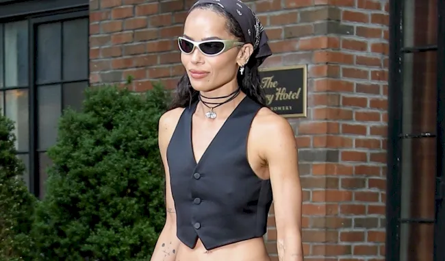 Braless Zoe Kravitz walking out of her hotel in NYC wearing a tiny vest