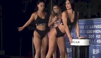 Two sexy women dressed in tiny sports wear having a butt slap competition