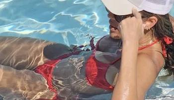 Jessica Alba lounging in a pool wearing a red bikini