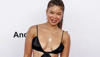 Black girl showing cleavage in a sexy dress on the red carpet
