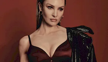 Model Candice Swanepoel posing in a shiny maroon bra