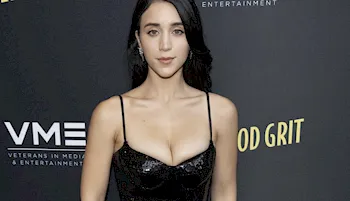 Breasty brunette showing cleavage in a black dress