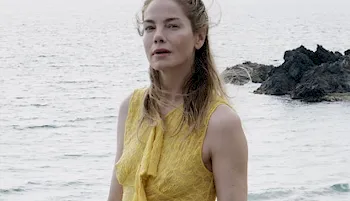Actress Michelle Monaghan braless in a yellow dress by the beach