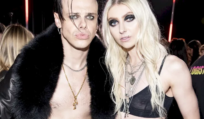 Taylor Momsen wearing a tiny see through top while posing next to an ugly man