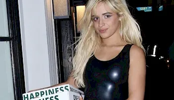 Camila Cabello in a rubber dress and holding pizza boxes