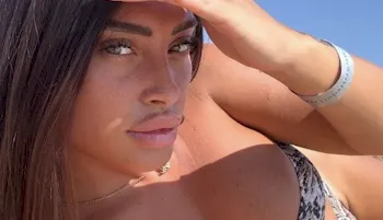 Sexy brunette looking seductively into the camera for a selfie