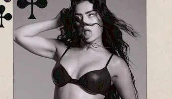 Charli XCX sticks her tongue while posing in a bra