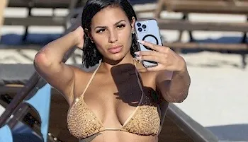 Hot babe in a bikini snapping a selfie at the beach