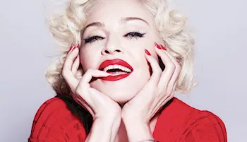 Madonna with her head in her hands and smiling
