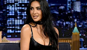 Kim Kardashian sits in a chair on The Tonight Show