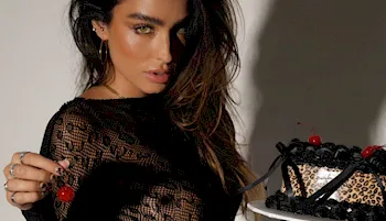 Sexy babe looking seductively while holding a cake