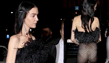 Fashion model out in the night wearing a sheer dress and white underwear