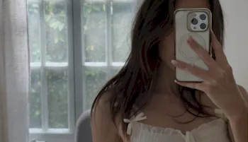 Brunette snaps a selfie with her phone in front of her face