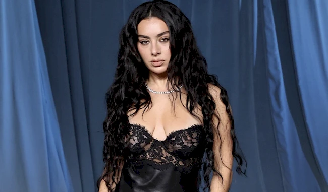 Charli XCX in a black and see through lace dress