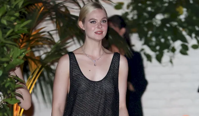 Elle Fanning braless in a sheer dress outside a Hollywood party