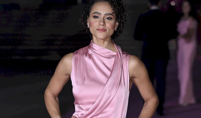 Cropped view of Nathalie Emmanuel putting her hands on her hips on the red carpet