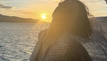 Halle Berry in front of a nice sunset over the ocean