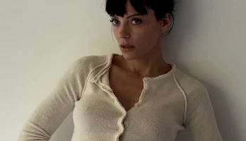 Cropped from chest up photo of girl modeling in shirt