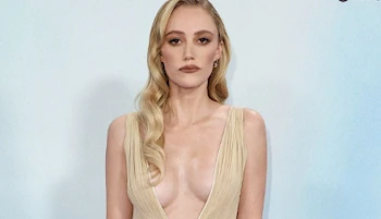 Frontal close up view of Maika Monroe showing cleavage on the red carpet