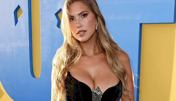 Sexy Latina blonde showing cleavage in a black dress