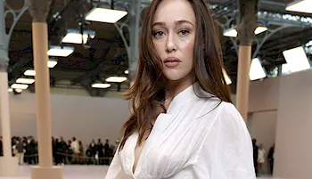 Alycia Debnam-Carey posing in a white dress