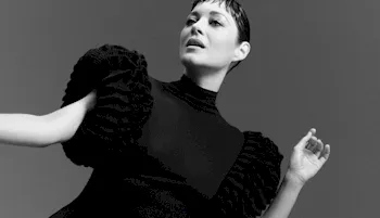 Black and white photo Marion Cotillard posing in a black dress