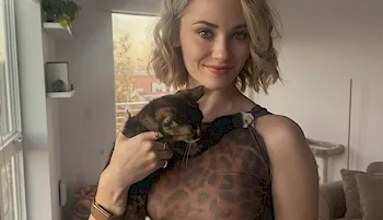Pretty blonde holding a cat and wearing a sheer leopard top