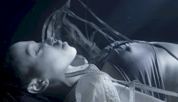 FKA Twigs laying down under water