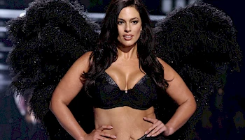 Ashley Graham on the runway in a black bra and black angel wings