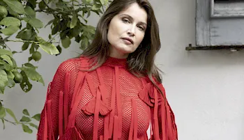 Laetitia Casta posing in a red dress