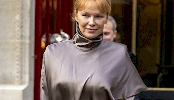 Pamela Anderson wearing silk dress outside a building in Paris