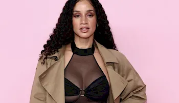 Dascha Polanco close up against a pink background