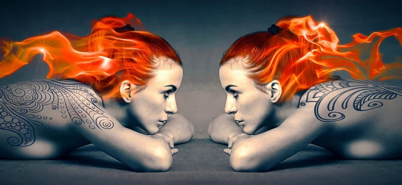 AI mirrored image of nude woman on her stomach and with her red hair on fire