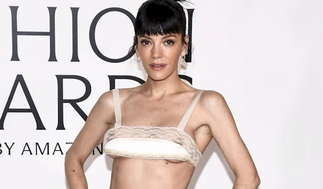Cropped view of Lily Allen wearing a small top on the red carpet