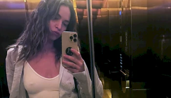 Cropped version of woman taking a selfie in an elevator