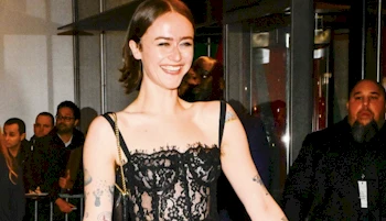 Cropped from chest up of smiling girl walking by outside an event venue