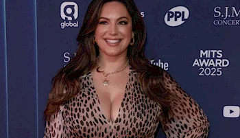 Close up of smiling woman posing in a leopard dress