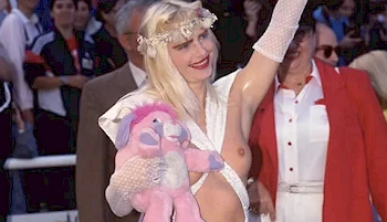 Cropped version of Ilona Staller waving on the red carpet in a revealing dress