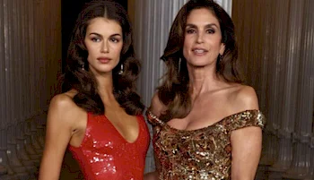 Cropped version of beautiful mother and daughter posing together on the red carpet