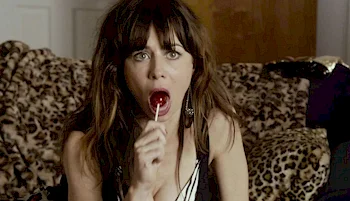 Close up of woman sticking a lollipop into her mouth
